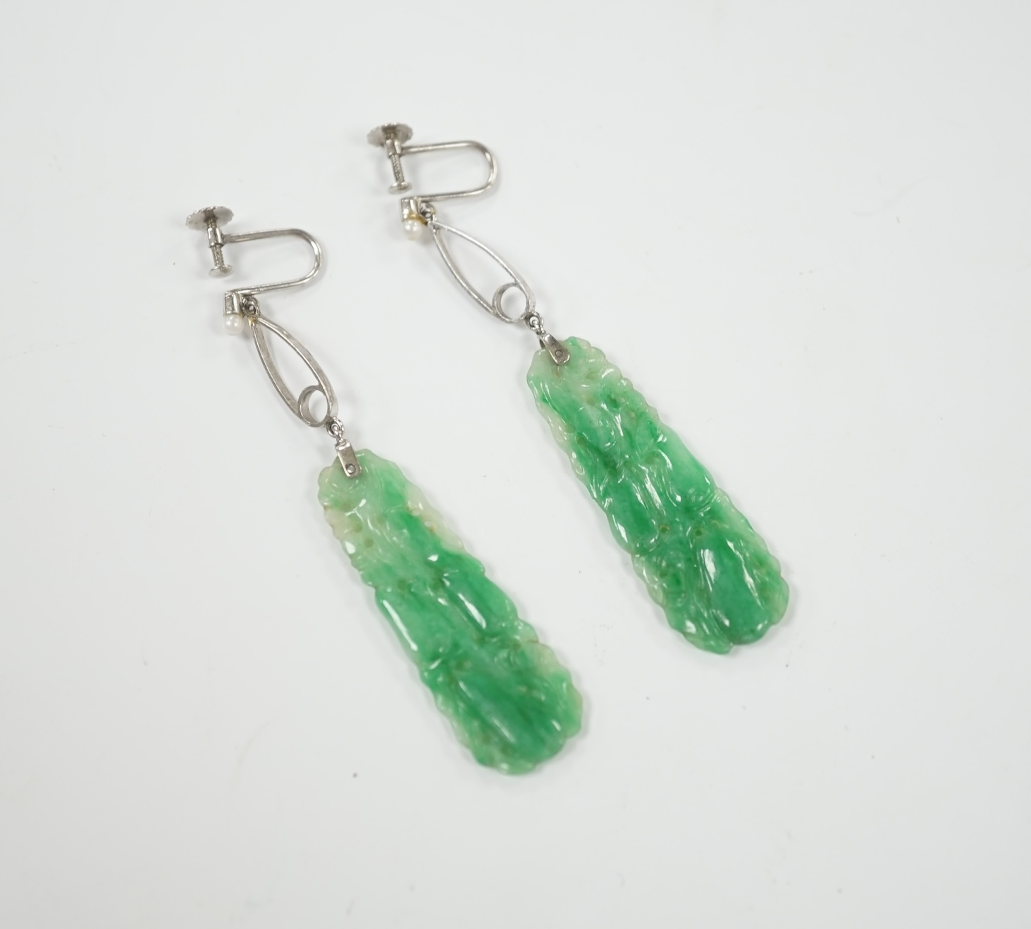 A pair of 9ct white metal, seed pearl and carved jade set drop ear clips, overall 7cm.